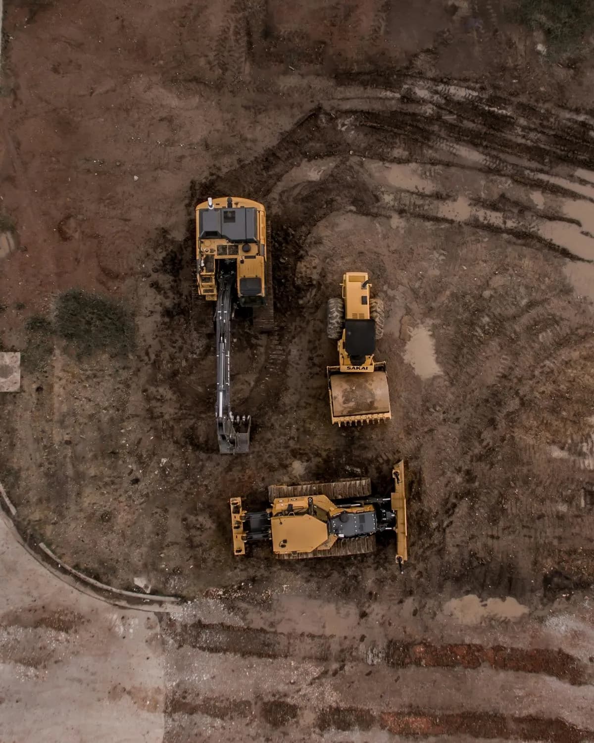 Aerial view of excavator, road roller and bulldozer fleet on site